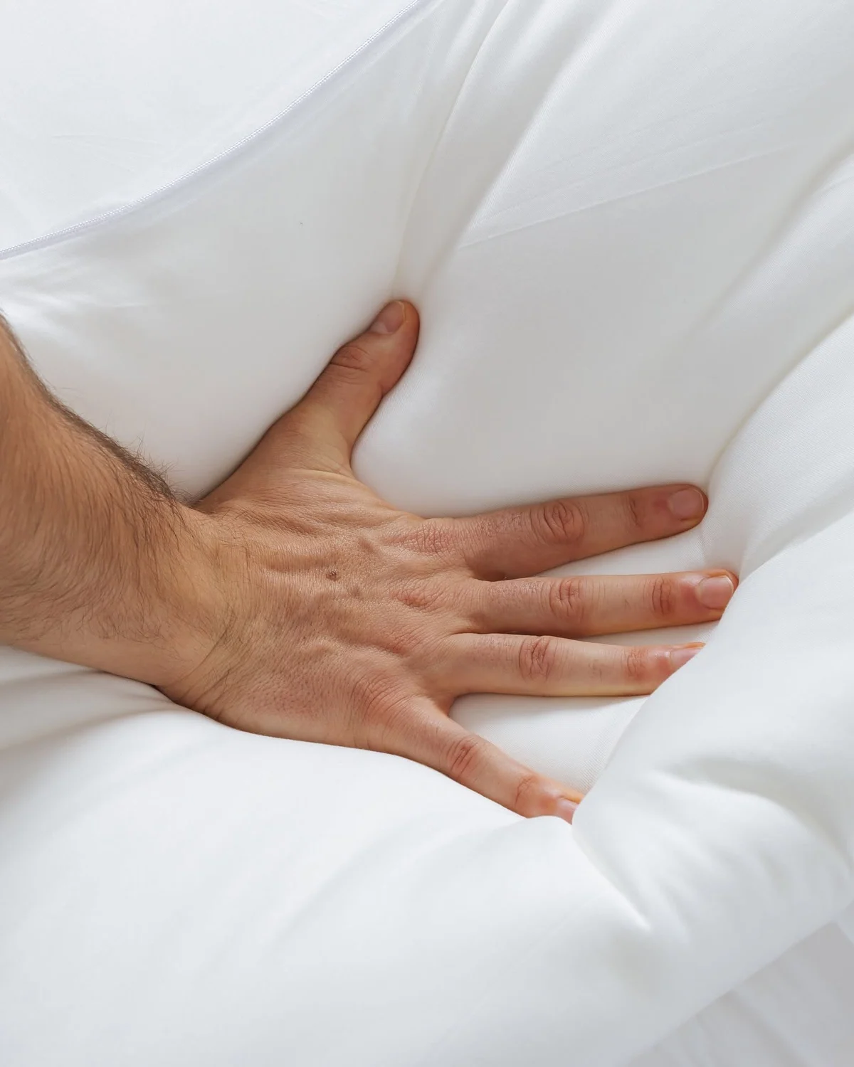 Hand pressing into the responsive OrthoAlign pillow surface